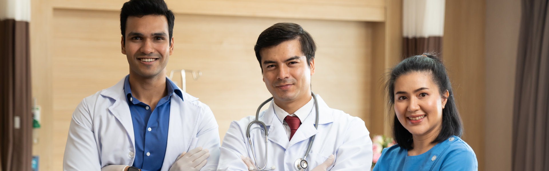 Portrait Of Male Doctors And Nurse Team In Patient Room At The Hospital
